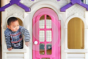 A kid inside a doll house