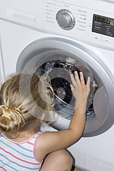 Kid interested in washing machine