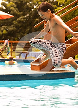 Kid jumping into the pool