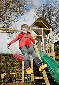 Kid jumping from swing