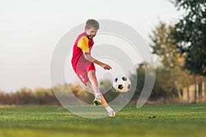 Kid kicking a soccer ball