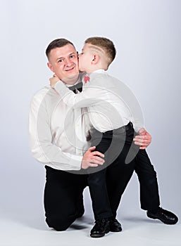 Kid kiss his father. tuxedo style. little boy with dad businessman. family day. esthete. male fashion. happy child with