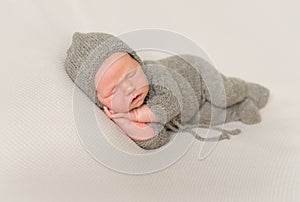 Kid in a knitted costume sleeping