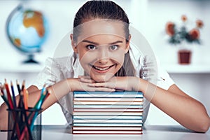 Kid is Leaned to Books Stack at Primary School.