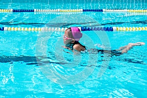 Kid learn how to swim in swimming class photo