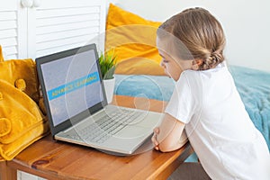 Kid learning at home. Little child girl using laptop. Advance learning and Distance education concept