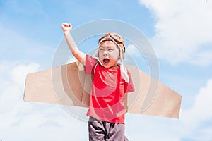 Kid little boy smile wear pilot hat play with toy airplane wing flying