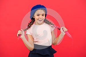 Kid little cute girl smiling face posing in hat red background. How to wear french beret. Beret style inspiration. How