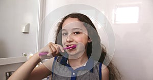 Kid little girl daily healthcare routine. Child with white tooth looking at mirror isolated at home. Smiling Lifestyle
