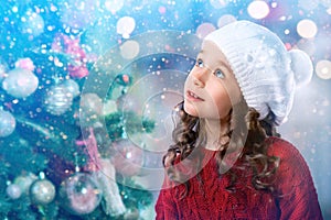 Kid little girl near Christmas tree. New Year card