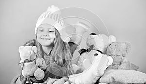 Kid little girl play with soft toy teddy bear pink background. Softness is key. Child small girl playful hold teddy bear