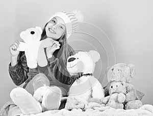 Kid little girl play with soft toy teddy bear on pink background. Toy every child dreaming. Happy childhood concept