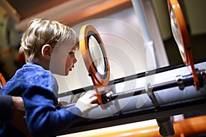 Kid looking through magnifying glass system