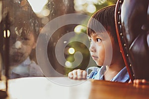 Portraits of people thinking. Kid looking out window.