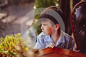 Kid looking out window. Portraits of people thinking.