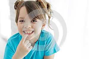 The kid lost a tooth. Baby without a tooth. Portrait of a little girl no tooth.