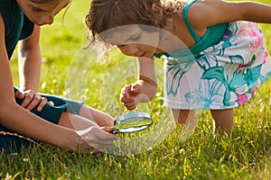 Kid with magnifying glass photo