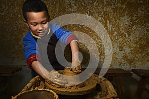 Kid making pottery