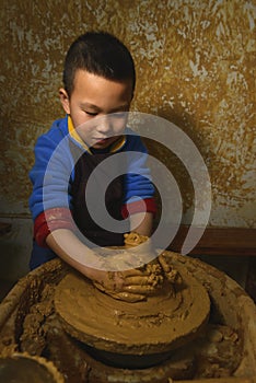 Kid making pottery