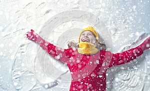 Kid making snow angel.