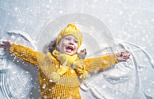Kid making snow angel.