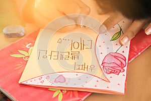 Kid making Valentine`s card for learning in holiday
