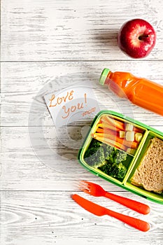 Kid menu lunchbox for school top view on wooden background