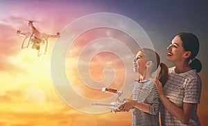 Kid and mom playing with drone