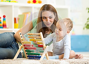Kid and mother playing with abacus