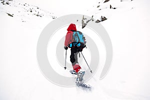 Kid in mountain with snowshoe