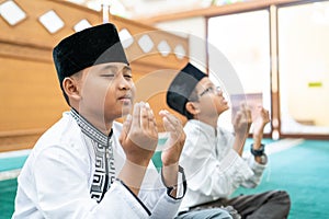 Kid muslim praying to god