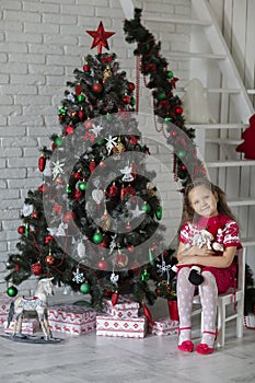 Kid near new-year tree