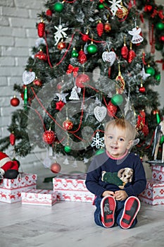 Kid near new-year tree