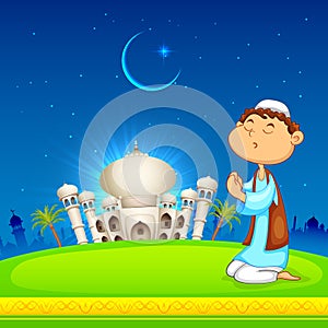 Kid offering namaaz for Eid celebration photo
