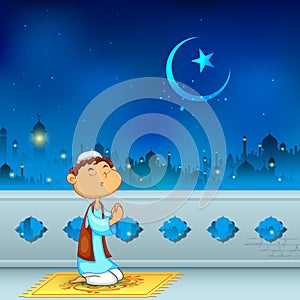 Kid offering namaaz for Eid celebration photo