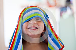 Kid out of the bath with wet hair and towel