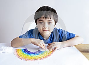 Kid painting rainbow on white paper. DIY Cotton wool as decorative elements for clouds on rainbow. Child Stay at home Social media