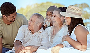 Kid, parents and grandparents picnic in park, happy family have fun and spending time together in New Zealand. Nature