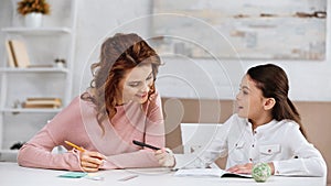 Kid with pen talking to mother