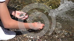 Kid Picking River Stone by Mountain Waterfall, Tourist Child Playing in Water, Girl Hands in Spring Stream Hiking at Camping Trip