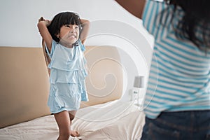 Kid pillow fight on the bed