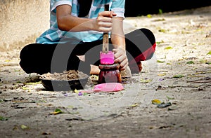 Kid plan sand with plastic toy in the park