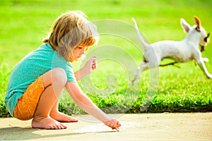 Kid play with puppy dog outdoor. Portrait of kid in spring park outdoors. Close-up face child playing outdoors in summer
