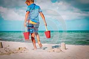 Kid play with sand on tropical beach