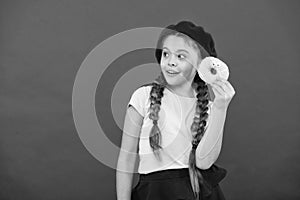 Kid playful girl ready to eat donut. Sweets shop and bakery concept. Kids huge fans of baked donuts. Impossible to