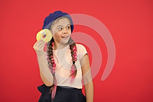 Kid playful girl ready to eat donut. Sweets shop and bakery concept. Kids huge fans of baked donuts. Impossible to