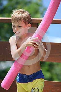 Kid playing around the pool