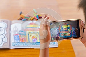 :kid playing Augmented Reality popup paintings of the color filled Taj Mahal via mobile