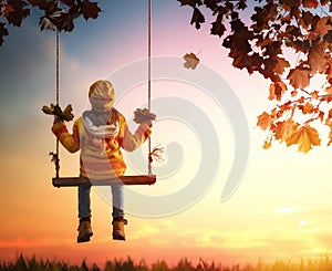 Kid playing in the autumn