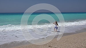 Kid Playing on Beach, Child Running on Seashore at Sunset, Little Girl Watching Sea Waves on Coastline Shore in Summer Vacation